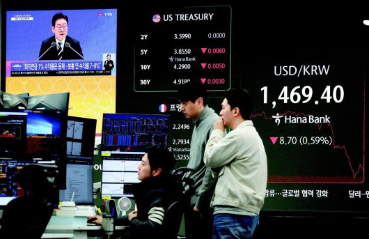 이재명 대통령의 신년 기자회견이 열린 21일 오전 서울 중구 하나은행 딜링룸 전광판에 원·달러 환율이 장중 한때 1,469.4원을 기록하고 있다. 뉴시스