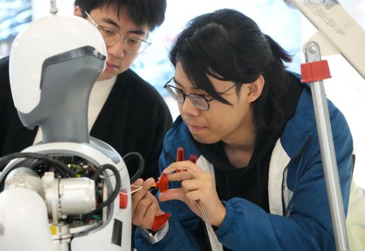 중국 항저우에서 로봇 스타트업 딥로보틱스 엔지니어들이 2월 28일 개발 중인 휴머노이드 로봇을 점검하고 있다.