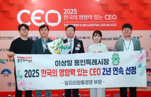 이상일 용인특례시장이 4일 서울시 더플라자 호텔에서 열린 '2025 한국의 영향력 있는 CEO 시상식'에서 일자리창출경영 부문 2년 연속 수상을 기념해 축하 인사들과 플래카드, 꽃다발을 들고 있다.