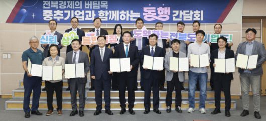 ▲'중추기업 전담제' 협약에 참여한 도내 중견기업 대표들이 김관영 전북지사와 함께 협약서를 들어 보이며 기념촬영을 하고 있다. ⓒ전북특별자치도