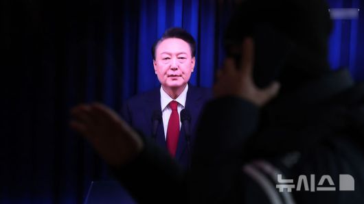 [서울=뉴시스] 추상철 기자 = 7일 오전 서울 용산구 서울역에서 시민이 윤석열 대통령의 대국민 담화 TV를 시청하고 있다. 2024.12.07. scchoo@newsis.com