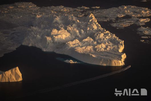 [일루리사트=AP/뉴시스] 지난 2월 18일(현지 시간) 그린란드 일루리사트에서 배 한 척이 거대한 빙산 옆을 항해하고 있다. 도널드 트럼프 미국 대통령이 그린란드에 야욕을 거침없이 드러내는 가운데, 미국과 덴마크 외교장관이 오는 3일 첫 회동하는 것으로 알려졌다. 2025.04.01.