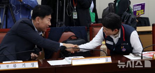 [세종=뉴시스] 강종민 기자 = 22일 세종시 정부세종청사에서 열린 최저임금위원회 제1차 전원회의에 앞서 류기정 사용자 위원과 이미선 근로자 위원이 악수하고 있다. 2025.04.22. ppkjm@newsis.com