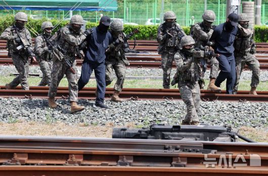 [부산=뉴시스] 하경민 기자 = 2025년 충무훈련의 하나로 '도시철도 피해복구 종합 실제훈련'이 열린 23일 부산 금정구 도시철도 1호선 노포차량정비창에서 군사경찰 대테러특임대가 테러범을 제압하고 있다.  전시 적 공격으로 인한 도시철도 시설피해 발생에 대비한 민·관·군·경·소방 합동훈련에는 53사단 부산여단과 부산교통공사, 금정구청, 금정소방서, 보건소, 부산항만공사, 금정결찰서 등 7개 기관 200여 명이 참가했다. 2025.04.23. yulnetphoto@newsis.com