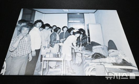 [광주=뉴시스] 이영주 기자 = 6일 오후 광주 동구 옛적십자병원에서 이창성 전 중앙일보 기자가 5·18 당시 촬영했던 병원 내 헌혈 장면이 담긴 사진이 전시되고 있다. 옛적십자병원은  5·18민주화운동 45주기를 맞아 5월 한달 동안 임시개방된다. 2025.05.06. leeyj2578@newsis.com