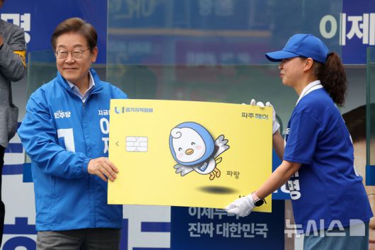 [파주=뉴시스] 조성우 기자 = 이재명 대통령이 대선 기간 경기 파주시 금릉역 중앙광장에서 경기지역화폐 파주페이 모형을 들어보이고 있다. 2025.05.20. xconfind@newsis.com