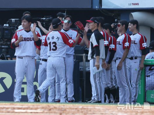 [서울=뉴시스] 배훈식 기자 = 22일 오후 서울 송파구 잠실야구장에서 열린 2025 신한 쏠뱅크 KBO리그 LG 트윈스와 두산 베어스의 경기, 2회까지 무실점한 LG 송승기가 동료들과 하이파이브를 하며 덕아웃으로 들어가고 있다. 2025.06.22. dahora83@newsis.com