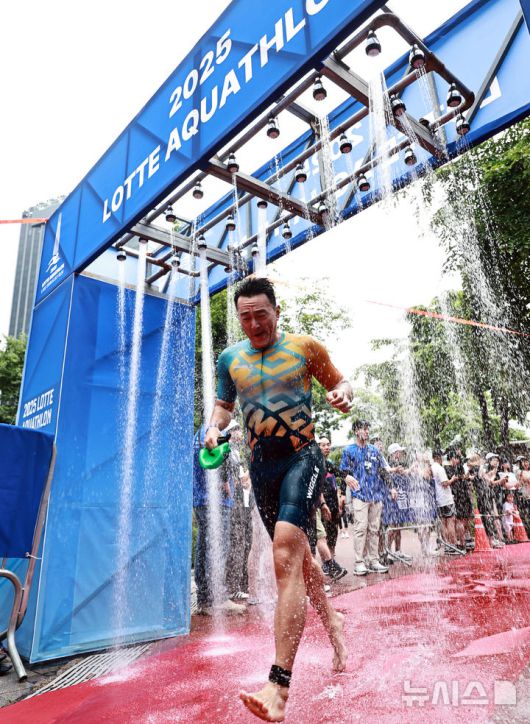 [서울=뉴시스] 김근수 기자 = 6일 오전 서울 송파구 롯데월드타워 일대에서 열린 '2025 롯데 아쿠아슬론'에서 참가자들이 수영 출발점에서 이동하고 있다. 철인 3종 경기에서 사이클론을 제외한 오픈워터 수영과 마라톤을 함께 겨루는 '2024 롯데 아쿠아슬론'은 석촌호수 두 바퀴(총 1.5Km)를 완영 후, 롯데월드타워 1층부터 123층까지 2,917개의 계단을 오르는 수직 마라톤 스카이런(SKY RUN)으로 진행됐다.(공동취재) 2025.07.06. photo@newsis.com