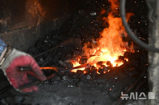 [광주=뉴시스] 이영주 기자 = 광주지역 최고기온이 37도까지 오른 29일 오후 광주 광산구 송정대장간에서 최종호(61) 송정대장간 대표가 약초를 캐는 도구를 만들고 있다. 광주지역에는 지난 20일 이후 현재까지 열흘 동안 폭염특보가 이어지고 있다. 2025.07.29. leeyj2578@newsis.com