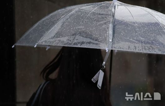 [제주=뉴시스] 우장호 기자 = 정체전선 영향으로 호우특보가 내려진 11일 오전 제주시 노형오거리 인근 거리에서 갑작스러운 비에 우산을 구입한 시민이 상표도 떼지 못하고 걸음을 재촉하고 있다. 2025.08.11. woo1223@newsis.com