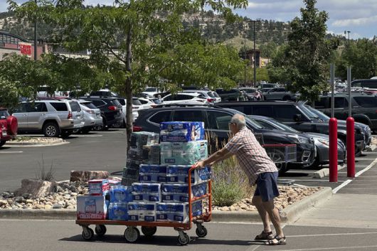 [콜로라도스프링스=AP/뉴시스] 지난 8월 12일(현지 시간) 미국 콜로라도주 콜로라도스프링스 소재 코스트코 주차장에서 한 쇼핑객이 카트를 밀고 있다. 2025.12.19.