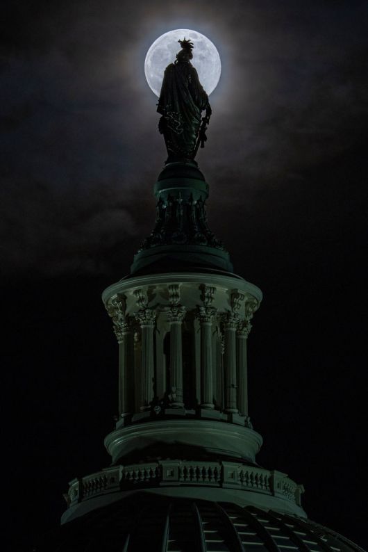 [워싱턴=AP/뉴시스] 4일(현지 시간) 미국 워싱턴에서 올해 마지막 보름달인 ‘콜드 슈퍼문’이 의사당 돔 꼭대기 '자유상'(Statue of Freedom) 뒤로 떠오르고 있다. 2025.12.05.