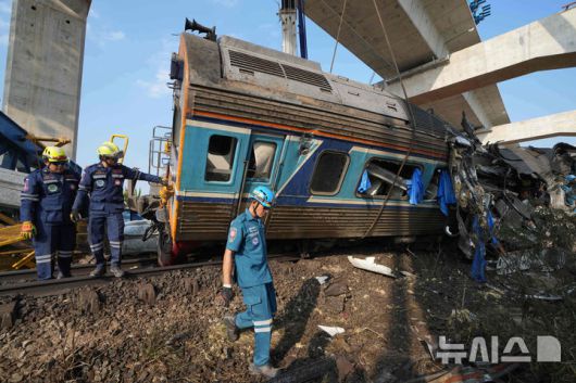[시키오=AP/뉴시스] 14일(현지 시간) 태국 나콘랏차시마주 시키오 고속철 공사장 크레인이 여객 열차로 추락한 현장에서 구조대가 열차 잔해를 수습하고 있다. 2026.01.15.