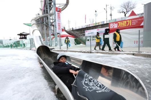 A visitor rides down a slide at the Hwacheon Sancheoneo Ice Festival in Hwacheon, Gangwon Province. Jan. 12, 2026. AJP Han Jun-gu