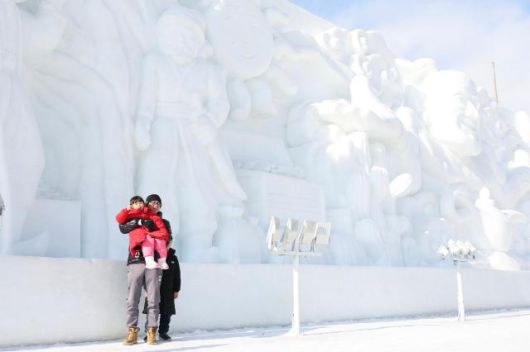 Visitors poses for a photo in front of giant ice sculptures at the Hwacheon Sancheoneo Ice Festival in Hwacheon, Gangwon Province. Jan. 12, 2026. AJP Han Jun-gu