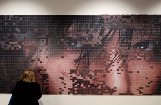 A visitor attaches a message card at the message zone for V at "V TYPE 非: ON-SITE IN SEOUL" held at Frieze Seoul in Jung-gu, Seoul, on Jan. 22, 2026.