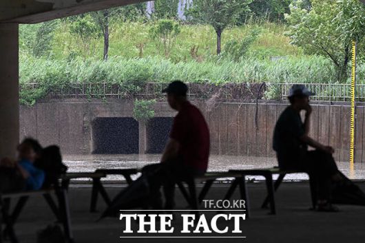 시민들이 양천교 아래에서 비를 피하고 있다.