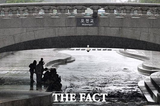 모전교 아래 비를 피하는 시민들.