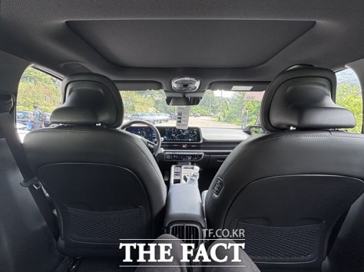 2열 좌석에서 바라본 실내 전경. 대시보드와 듀얼 스크린 구성이 보이며, 앞좌석 뒷면에는 수납망과 뒷좌석 전용 송풍구가 마련돼 있다. 뒷좌석에서도 전방 시야가 비교적 넓게 확보되는 구성이 특징이다. /황지향 기자