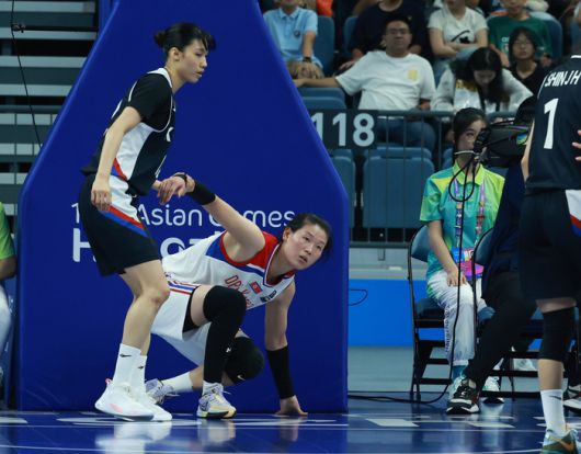 29일 중국 저장성 항저우의 올림픽 스포츠센터에서 열린 2022 항저우 아시안게임 여자 농구 대한민국과 북한의 경기에서 대한민국 이해란이 수비 과정에서 넘어진 북한 로숙영에게 손을 건네며 일으켜 주고 있다. 사진 | 항저우=연합뉴스