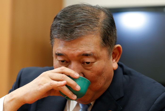 이시바 시게루 전 일본 자민당 간사장이 31일 도쿄 시내의 사무실에서 인터뷰를 하다가 물을 마시고 있다.  도쿄 | 로이터연합뉴스