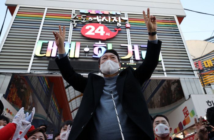 국민의힘 윤석열 대선 후보가 27일 오후 경북 포항시 죽도시장을 찾아 상인과 지지자들에게 인사하고 있다. 연합뉴스