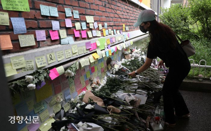 시민의 애도 지난 18일 교사가 극단적 선택을 한 서울 서초구 한 초등학교에서 24일 한 시민이 교사의 죽음을 애도하고 있다. 성동훈 기자 zenism@kyunghyang.com