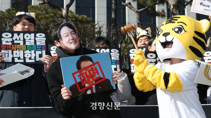 윤석열 물어가는 범청년행동 등 35개 청년단체 관계자들이 19일 서울 종로구 헌법재판소 앞에서 열린 윤석열 대통령 파면 촉구 기자회견에서 퍼포먼스를 하고 있다. 정효진 기자