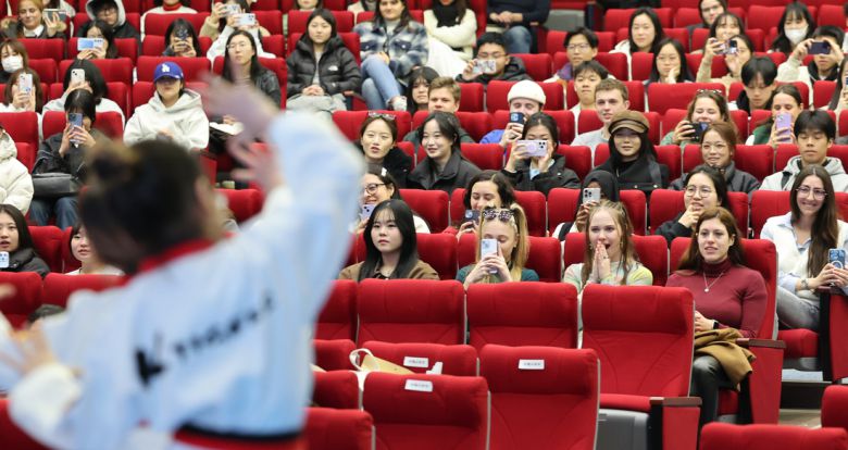 지난달 28일 부산 남구 국립부경대학교 대연캠퍼스 대학극장에서 열린 2025학년도 1학기 외국인 신입생 오리엔테이션에 참가한 외국인 유학생들이 태권도 시범공연을 즐기고 있다. 연합뉴스