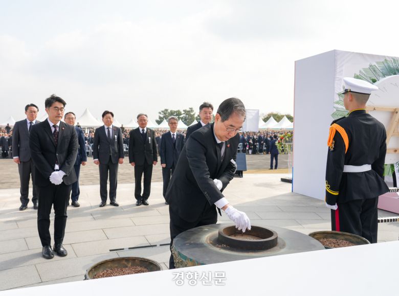 3일 제주4·3평화공원 위령제단·추념광장에서 열린 제77주년 4·3희생자 추념식에 참석한 한덕수 한덕수 대통령 권한대행 겸 국무총리가 헌화 분양하고 있다. 제주도 제공