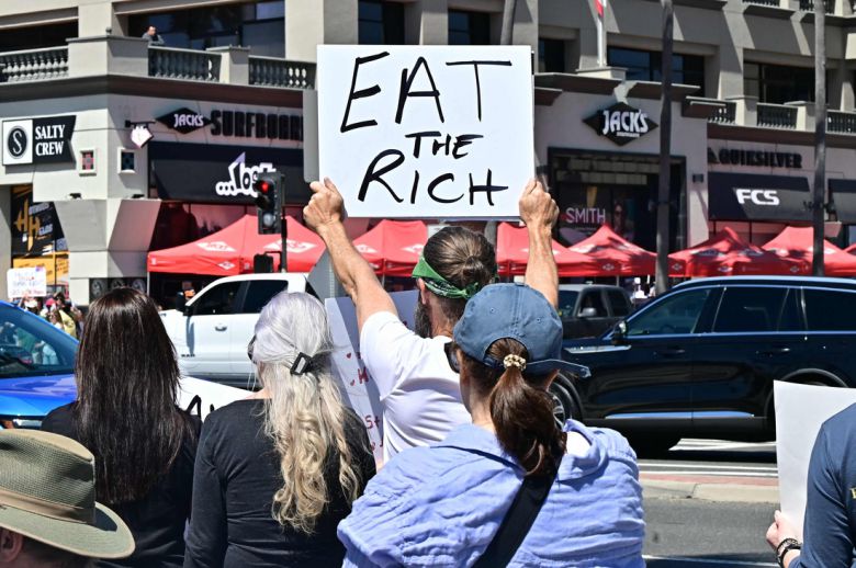 5일(현지시간) 미국 캘리포니아 헌팅턴 비치에서 도널드 트럼프 미국 대통령과 그의 고문 일론 머스크의 정책에 반대하는 시위에서 참가자가 팻말을 들고 있다. AFP연합뉴스