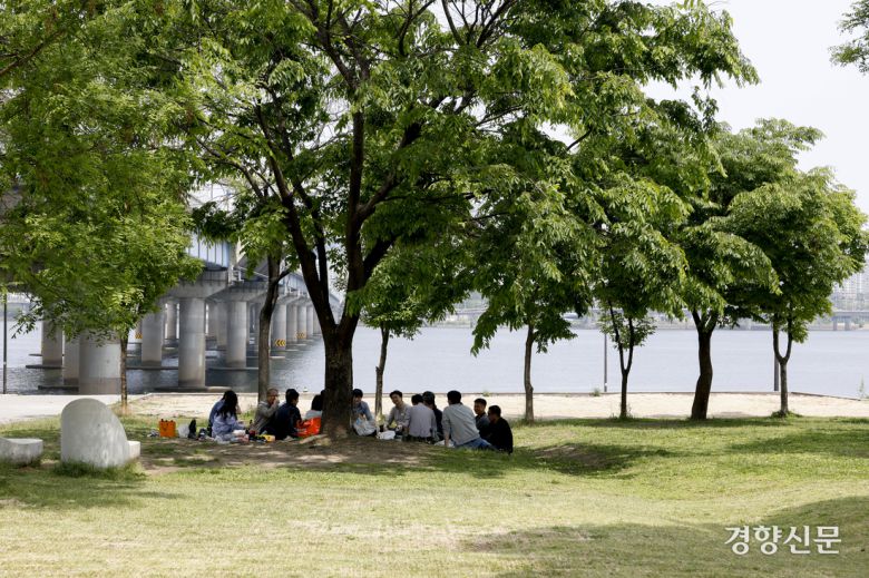 서울의 한낮 기온이 26도로 초여름 날씨를 보인 14일 서울 여의도한강공원을 찾은 시민들이 그늘에서 더위를 피하고 있다. 문재원 기자