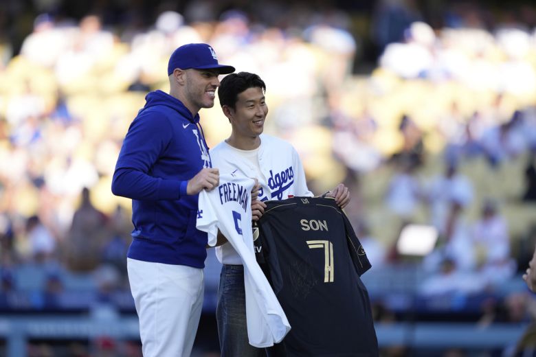 LAFC 손흥민(오른쪽)이 28일 메이저리그 LA 다저스-신시내티전에 시구자로 초청돼 LA 다저스 핵심타자 프레디 프리먼과 유니폼을 교환하기 전 기념촬영 하고 있다. 로스앤젤레스 | AP연합뉴스