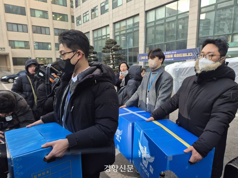 북한의 한국 무인기 침투 주장 등을 수사하고 있는 군·경 관계자들이 21일 서울의 한 사립대학 건물을 압수수색한 뒤 압수물품을 들고 이동하고 있다. 김태욱 기자