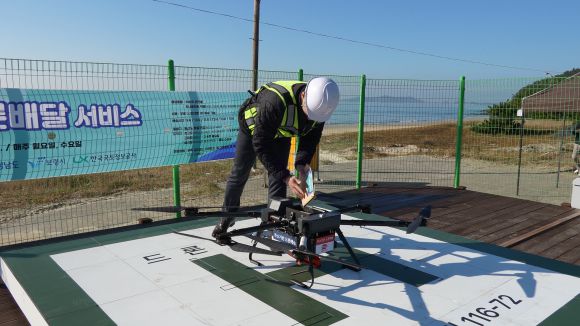 행정안전부가 지난달 21일 충남 보령에서 진행한 섬지역 드론 배송 실증 시연에서 원산도에서 외연도로 보낼 물건을 드론에 싣고 있다.  행안부 제공