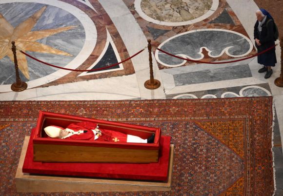 프랑스 출신의 제느비에브 자넹그로스 수녀가 지난 23일(현지시간) 바티칸 성 베드로 대성전에 안치된 프란치스코 교황의 관 곁에서 조문하고 있다. AFP 연합뉴스