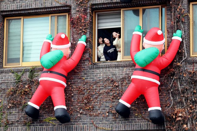 광주 북구청에 ‘산타 오셨네~’ - 4일 광주 북구청 공무원들이 청사 외벽을 장식한 산타클로스 인형을 살피며 즐거워 하고 있다. 북구는 크리스마스 시즌을 맞아 내년 초까지 산타클로스 인형을 내걸 예정이다. 광주 북구 제공