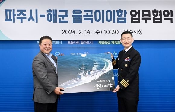 김경일 파주시장(왼쪽)과 김봉진 해군 대령이 2024년 2월 14일 업무협약을 체결하고 기념사진을 찍고 있다. [파주시 제공]