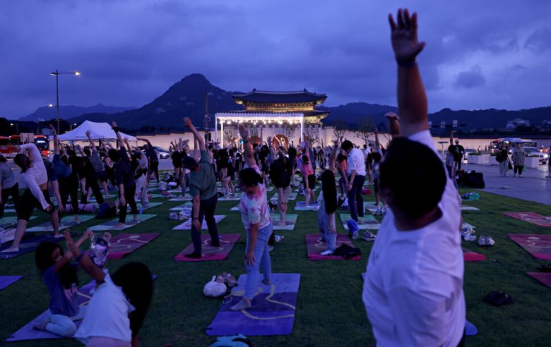 7월4일 저녁 서울 종로구 세종로 광화문광장에서 외국인을 위한 영어 요가가 열리고 있다. 참석자들이 강사의 안내대로 자세를 취하고 있다.