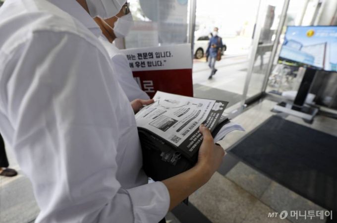 [서울=뉴시스] 고승민 기자 = 더불어민주당과 대한의사협회가 코로나19 안정화까지 의대정원 및 공공의대 확대 논의를 전면 중단하고 의료계도 집단휴진을 마치는 데 최종 합의한 4일 서울대병원에서 합의 소식이 타진되자 피켓시위를 하던 전공의들이 병원으로 돌아가고 있다. 2020.09.04.  kkssmm99@newsis.com