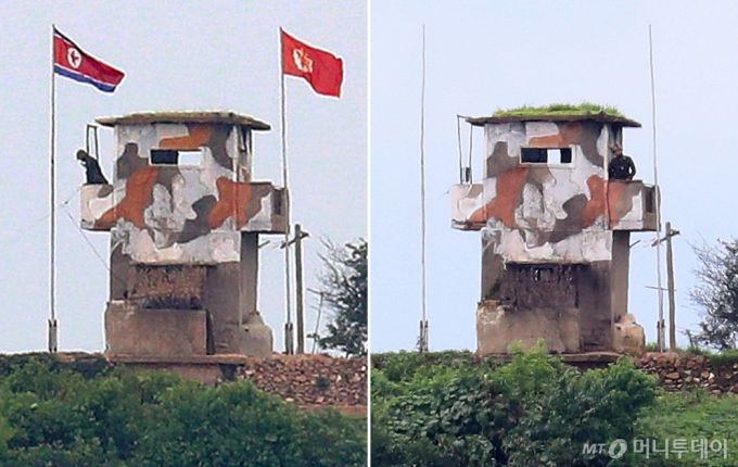 지난달 21일 경기 파주 접경지역에서 바라본 북한 초소(오른쪽)에 인공기와 최고사령관기가 내려가 있다. 왼쪽은 지난 6월 23일 북한의 대남 확성기 재설치 당시 깃발이 걸려있는 모습. / 사진=이기범 기자 leekb@