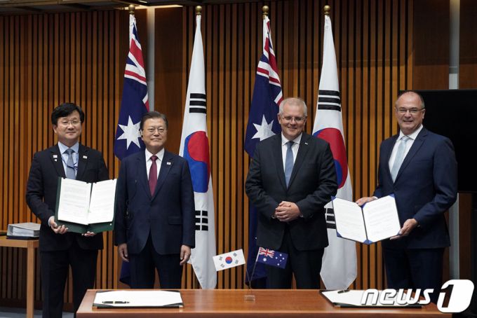 (서울=뉴스1) = 호주를 국빈 방문 중인 문재인 대통령이 13일 캔버라 국회의사당에서 열린 강은호 방위사업청장과 토니 프레이저 호주 CASG청장 사이의 한·호주 방위산업 및 방산물자 협력에 대한 양해각서 체결을 지켜본 뒤 스콧 모리슨 총리와 함께 기념촬영을 하고 있다.(청와대 제공) 2021.12.13/뉴스1