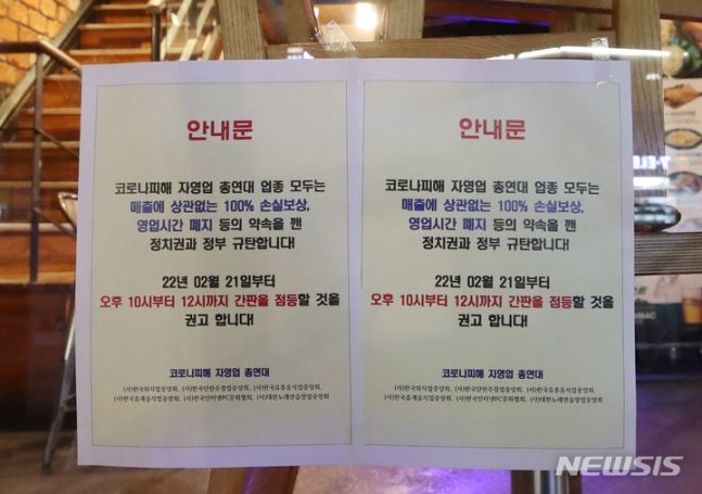 로나피해자영업총연합(코자총) 소속 서울 홍대입구역 인근 음식점 상인들이 지난 21일 코로나19 영업 제한시간인 오후 10시 이후 영업점 불을 켜고 점등 시위를 하고 있다. 간판 점등을 권고하는 안내문. /사진=뉴시스