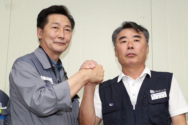 (서울=뉴스1) 신웅수 기자 = 권수오 녹산기업 대표(왼쪽)와 홍지욱 금속노조 부위원장이 22일 오후 경남 거제시 대우조선해양에서 협상 타결 합의문을 발표한 후 손을 맞잡고 있다. 2022.7.22/뉴스1