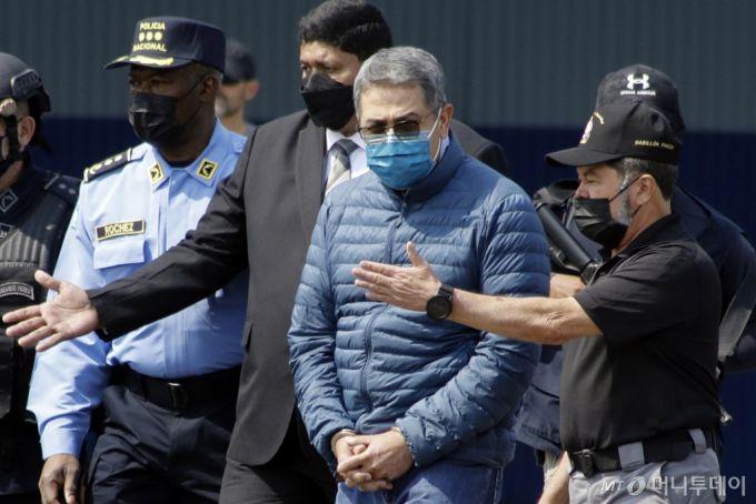 마약 범죄에 연루된 혐의를 받은 후안 올란도 에르난데스 전 온두라스 대통령(55)이 26일(현지시각) 미국 법원에서 징역 45년을 선고받았다. 사진은 수갑을 찬 에르난데스 전 대통령(오른쪽에서 두 번째)이 2022년 4월21일 미국 송환을 위해 온두라스 테구시갈파 공군기지에 도착한 모습. /AP=뉴시스