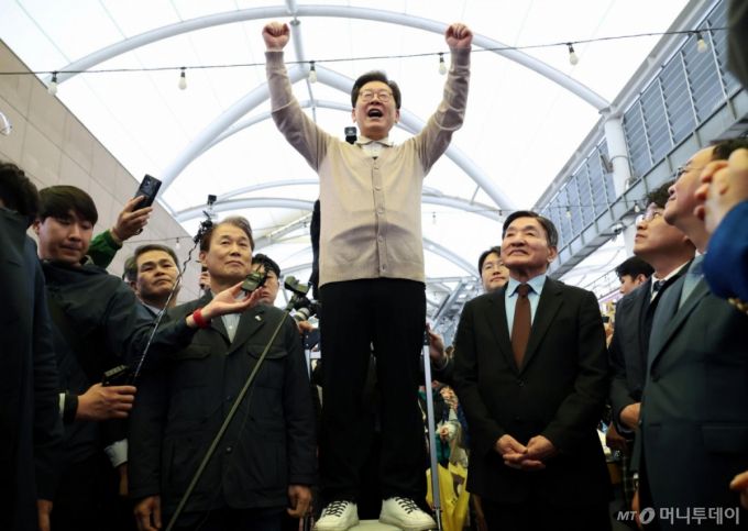 [성주=뉴시스] 조성우 기자 = 민심을 청취하는 '경청 투어'에 나선 이재명 더불어민주당 대선후보가 9일 경북 성주군 성주전통시장에서 즉흥 연설을 하다 손을 들며 주먹을 불끈 쥐고 있다. 2025.05.09.