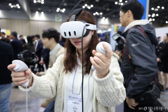 가상융합 산업대전. 가상융합 산업대전에서 한 관람객이 XR 안경을 체험하고 있다./사진제공=한국메타버스산업협회