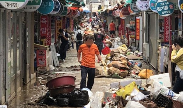 지난 24일 오후 부산 해운대구 해운대시장 일대에서 상인들이 집중호우 피해 복구를 하고 있다./연합뉴스