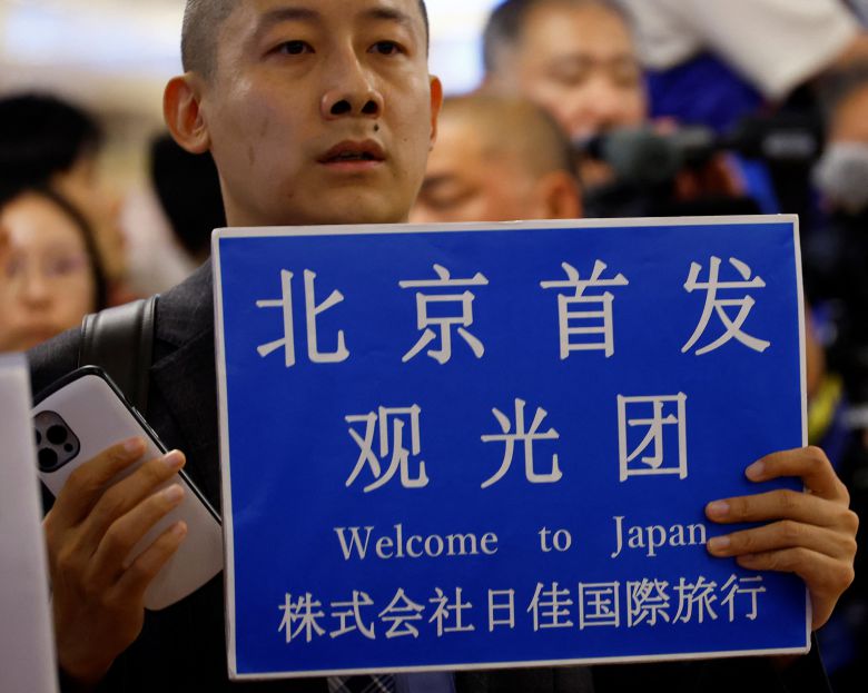 일본 도쿄 하네다공항에서 한 여행사 직원이 베이징에서 출발하는 중국인 여행단 도착을 기다리고 있다. /연합뉴스