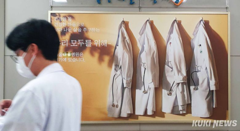 서울의 한 대학병원 로비에 걸린 병원 홍보물 옆으로 의료진이 이동하고 있다. 곽경근 대기자